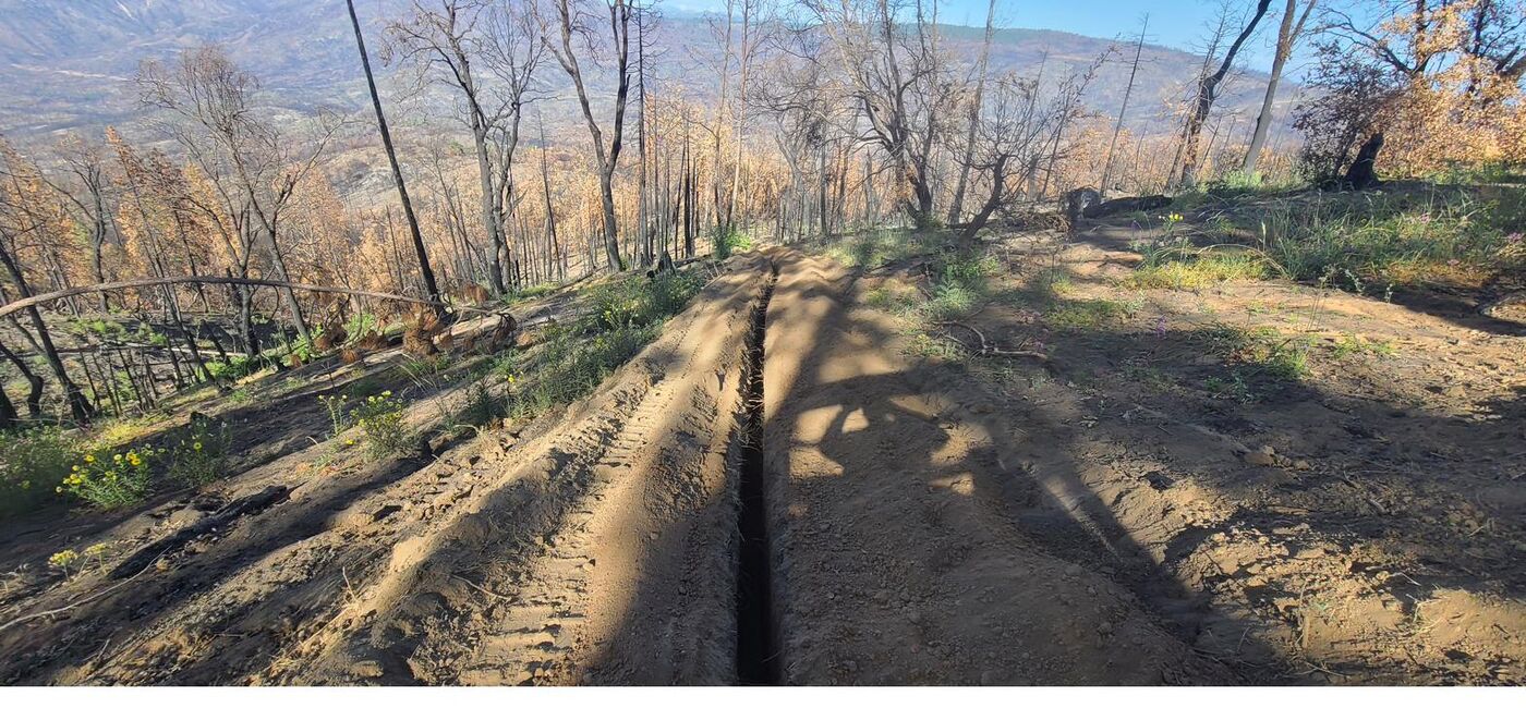 Utility trench cut through a post-fire California landscape